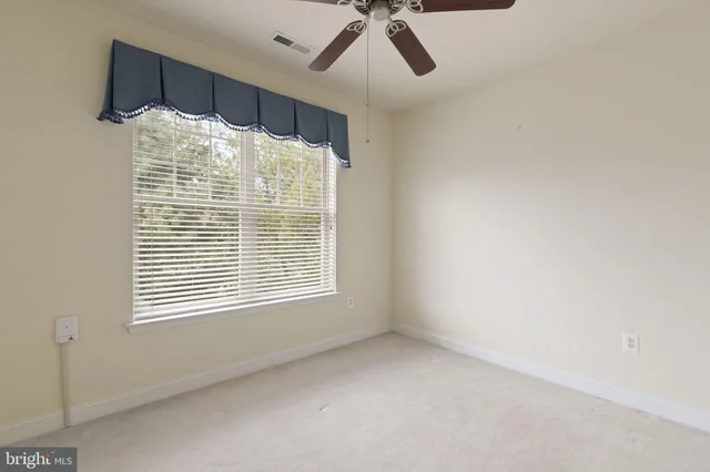 a bathroom with a large window and a shower