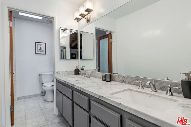a bedroom with furniture and a book shelf