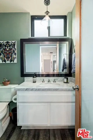 a front view of a house with a tree