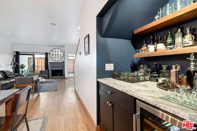 a kitchen with stainless steel appliances kitchen island granite countertop a dining table and chairs in it
