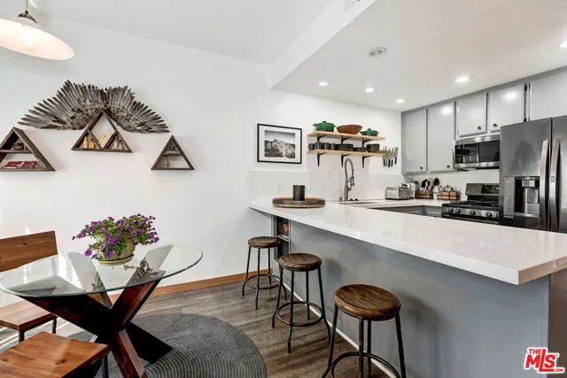 a view of a dining room with furniture and a chandelier