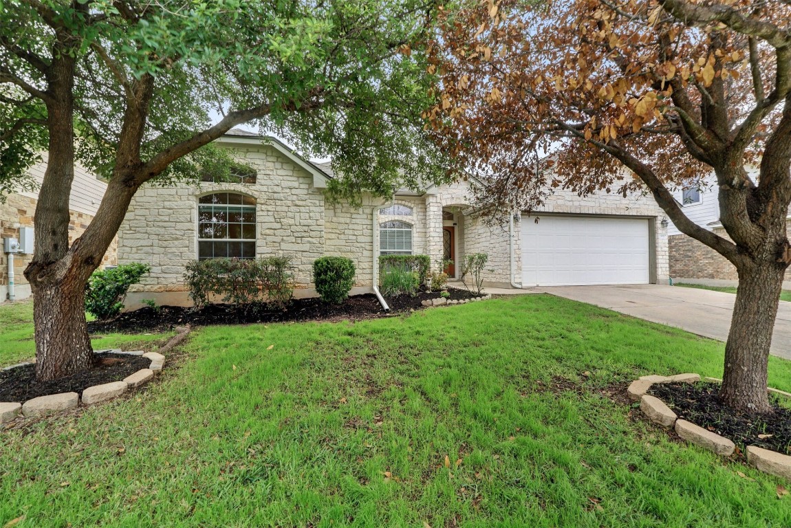 a front view of house with yard and green space