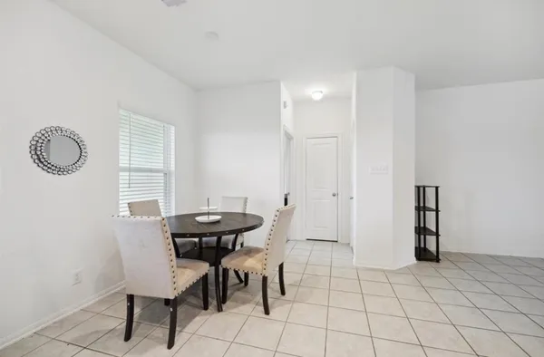 a view of a room with furniture and wooden floor