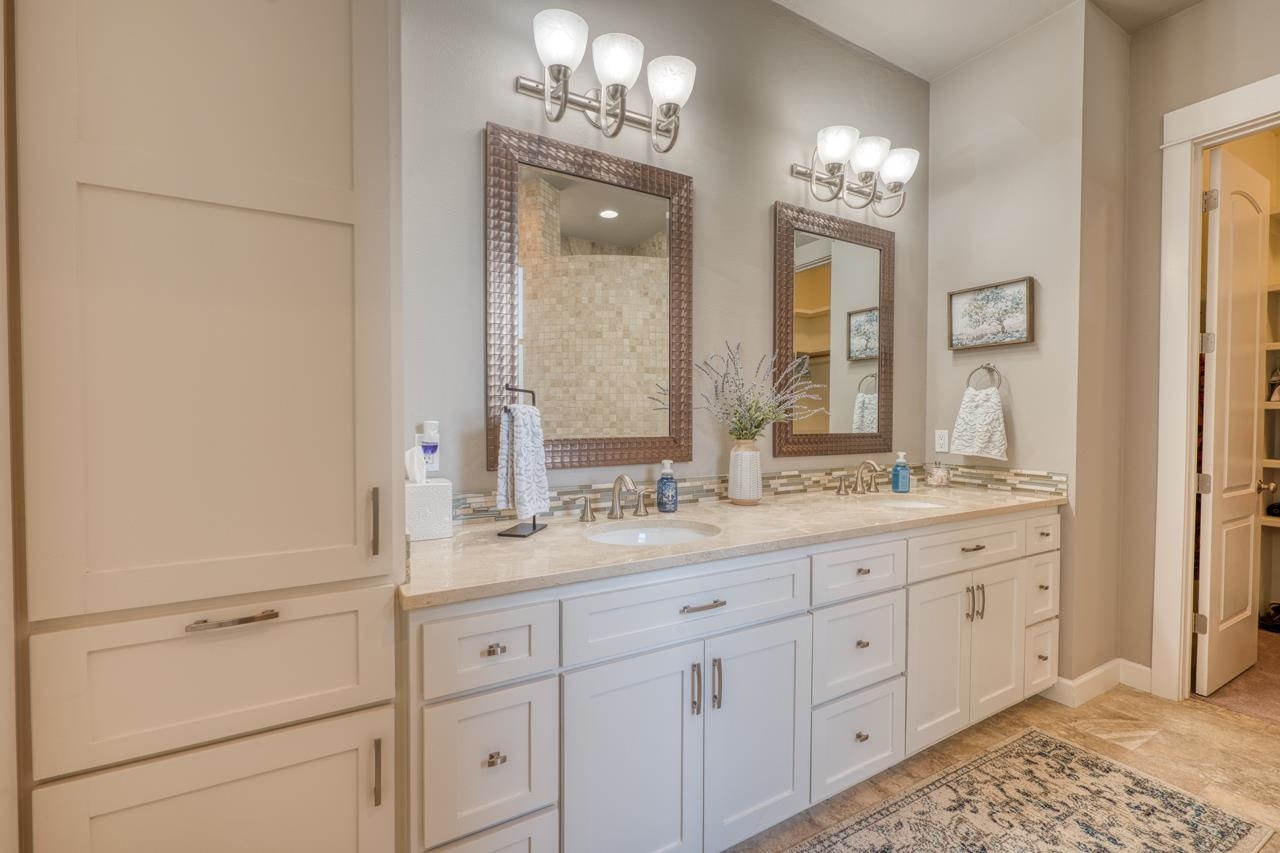 211 Chandler Way Kingsland, TX 78639 - Photo 14 of 40 a bathroom with a double vanity sink and a mirror