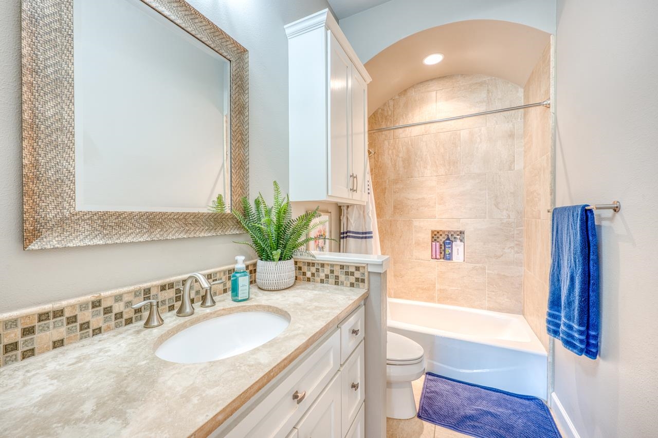 211 Chandler Way Kingsland, TX 78639 - Photo 19 of 40 a bathroom with a granite countertop sink toilet and shower