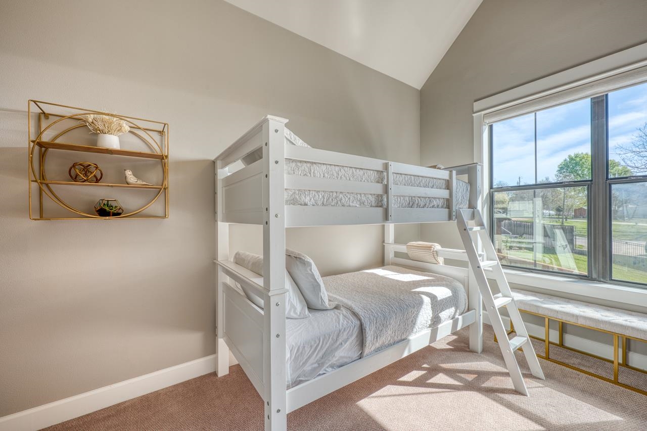 211 Chandler Way Kingsland, TX 78639 - Photo 22 of 40 a bed sitting in a room next to a window
