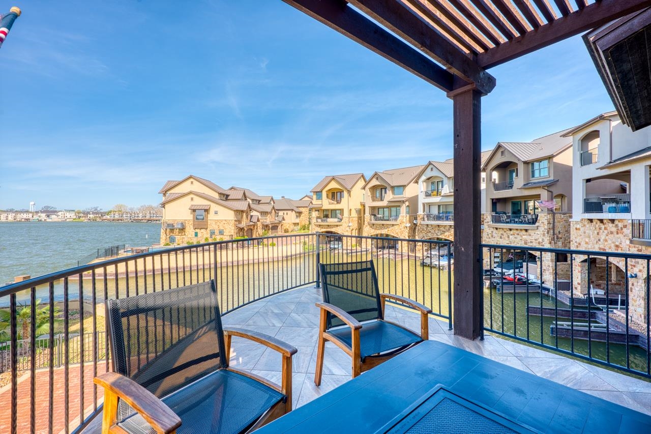211 Chandler Way Kingsland, TX 78639 - Photo 25 of 40 a view of a balcony with lake view and wooden floor