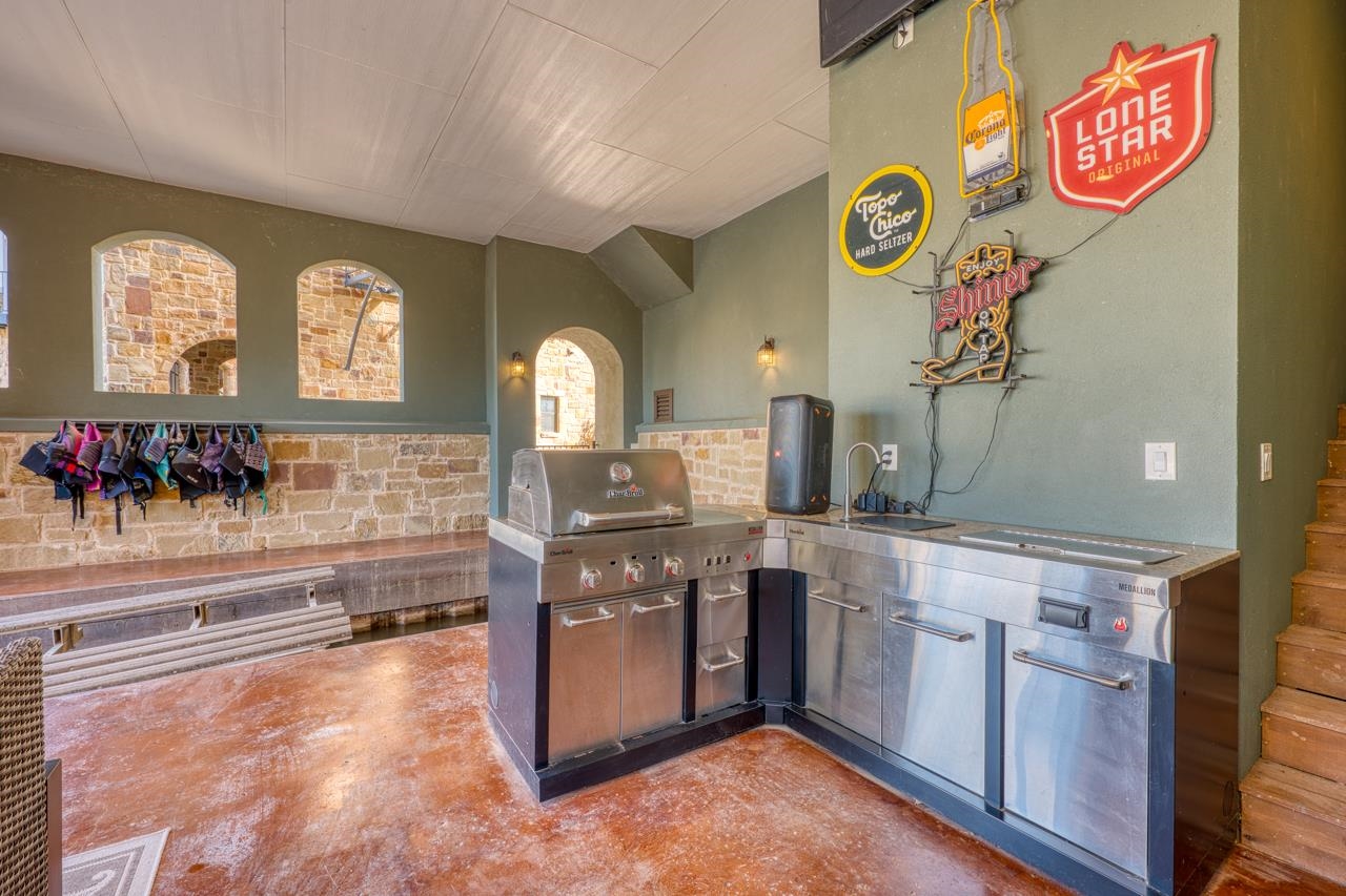 211 Chandler Way Kingsland, TX 78639 - Photo 29 of 40 a kitchen with stainless steel appliances granite countertop a stove and a sink