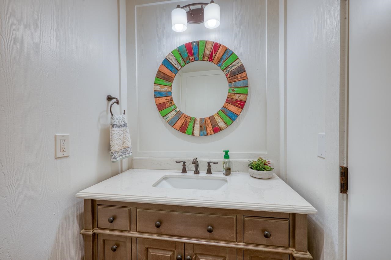 211 Chandler Way Kingsland, TX 78639 - Photo 30 of 40 a bathroom with a sink mirror and vanity
