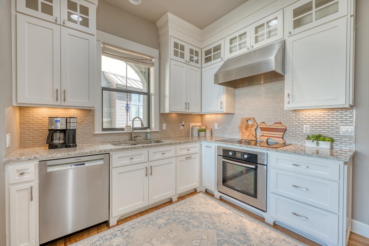 211 Chandler Way Kingsland, TX 78639 - Photo 7 of 40 a kitchen with cabinets appliances a sink and a window