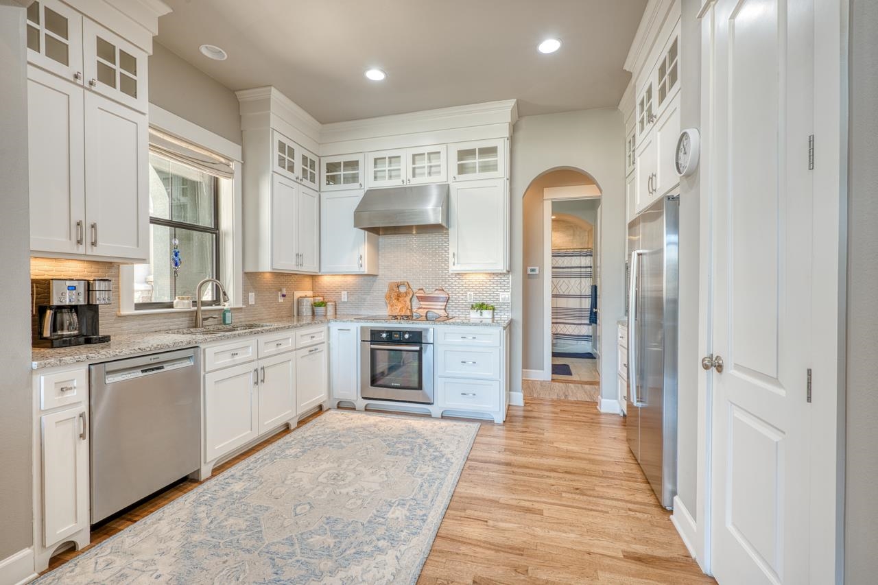 211 Chandler Way Kingsland, TX 78639 - Photo 8 of 40 a kitchen with white cabinets and appliances