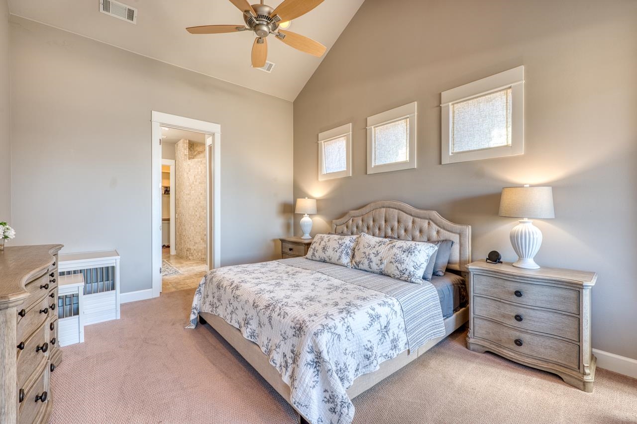211 Chandler Way Kingsland, TX 78639 - Photo 10 of 40 a bedroom with a bed and a chandelier