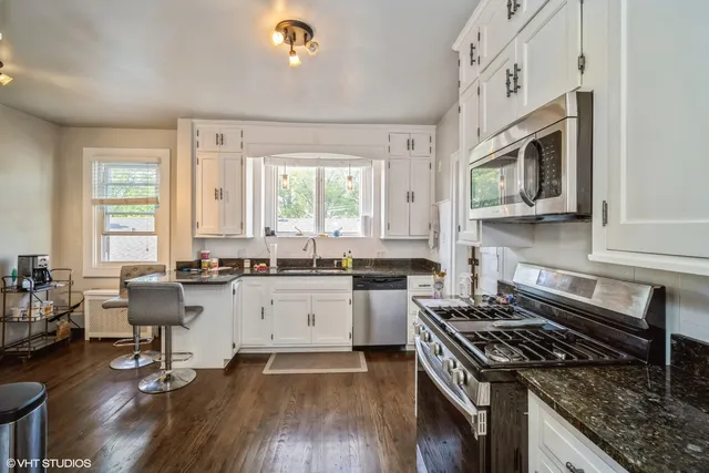 a kitchen with sink stove and cabinets