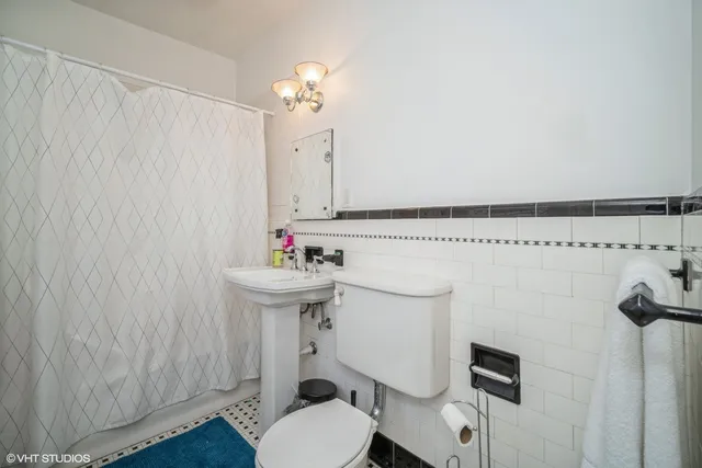 a bathroom with a sink a toilet and mirror
