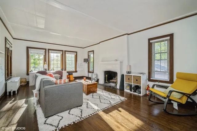 a living room with furniture a fireplace and a table