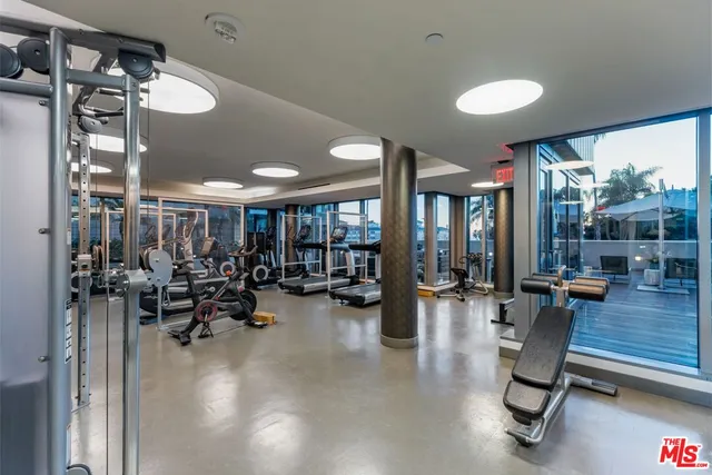 a view of a room with gym equipment and large window