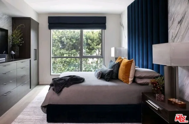 a bedroom with a bed lamp and window