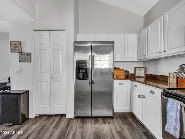 a kitchen with a refrigerator sink and cabinets