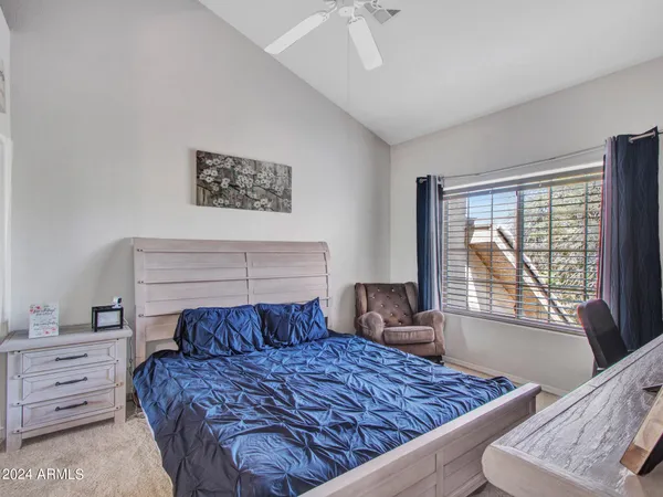 a bedroom with a large bed and a window