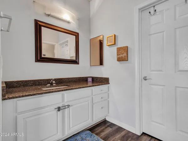a hallway with cabinets and painting on the wall