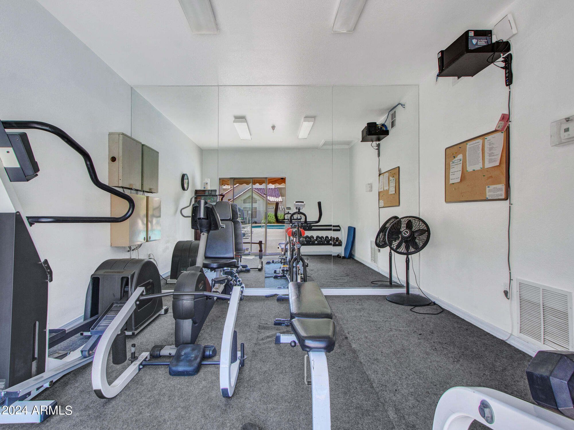 2801 North Litchfield Road, Unit 60 Goodyear, AZ 85395 - Photo 27 of 37 a living room with furniture a rug and white walls