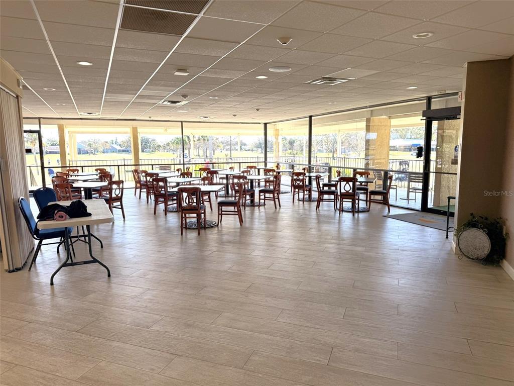 3244 Candle Ridge Drive, Unit 202 Orlando, FL 32822 - Photo 22 of 61 a dining room with furniture floor to ceiling window and wooden floor