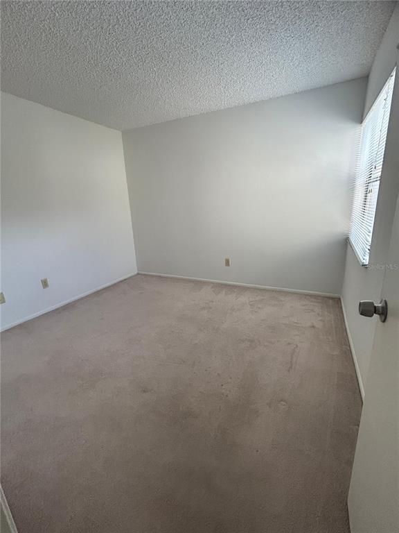 3244 Candle Ridge Drive, Unit 202 Orlando, FL 32822 - Photo 9 of 61 en empty room with windows