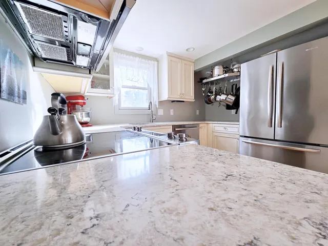 a kitchen with appliances cabinets and a window