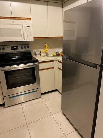 a kitchen with a stove cabinets and utility