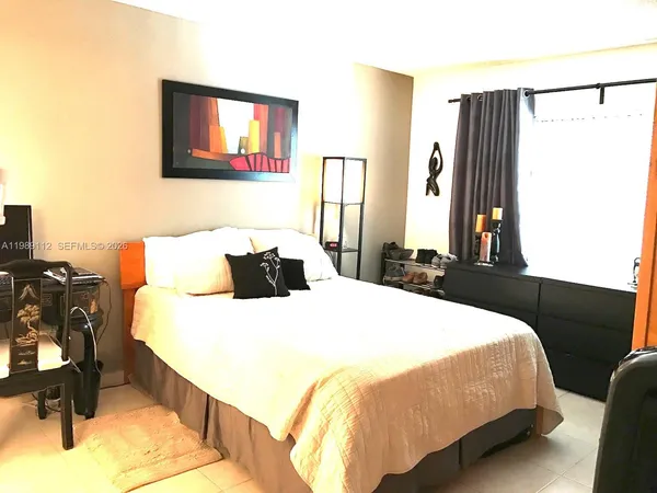a bedroom with a bed and dresser
