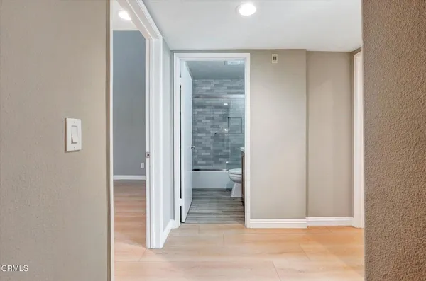 a view of a bathroom from a corridor