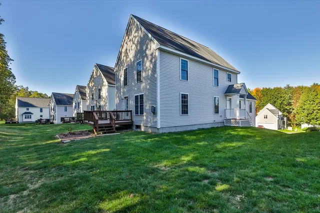 a view of a house with a backyard
