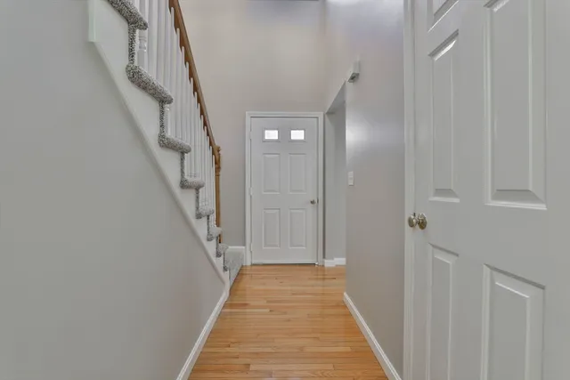 a view of a hallway with a white walls and stairs