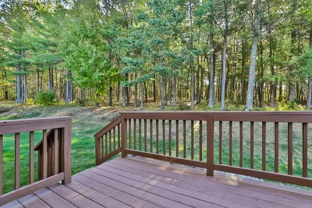 a view of a house with backyard and trees
