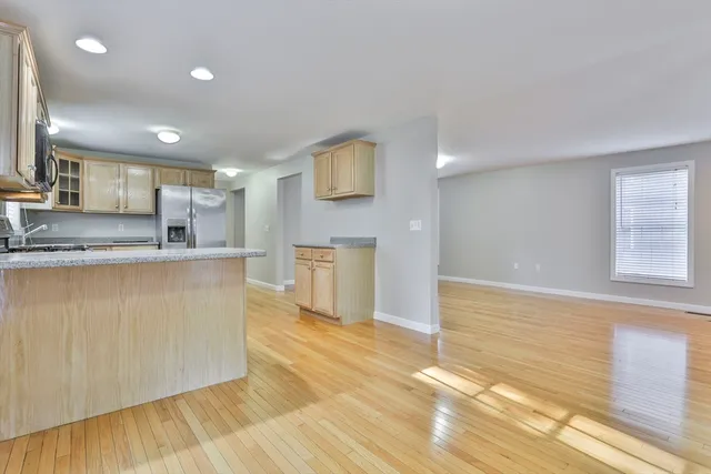 a kitchen with stainless steel appliances granite countertop a sink a stove top oven a counter space and cabinets