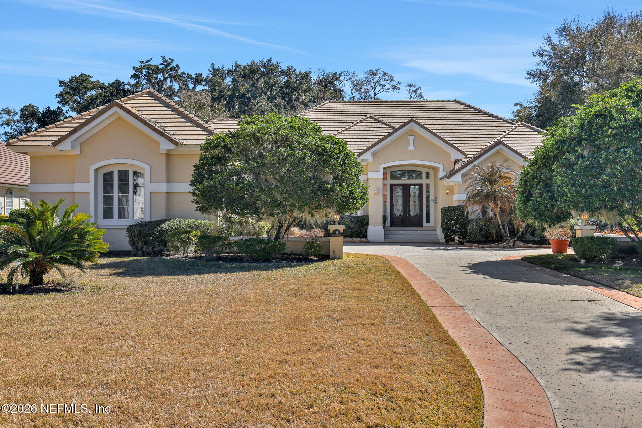 196 Governors Road Ponte Vedra Beach, FL 32082 - Photo 3 of 117 a front view of a house with a yard and garage