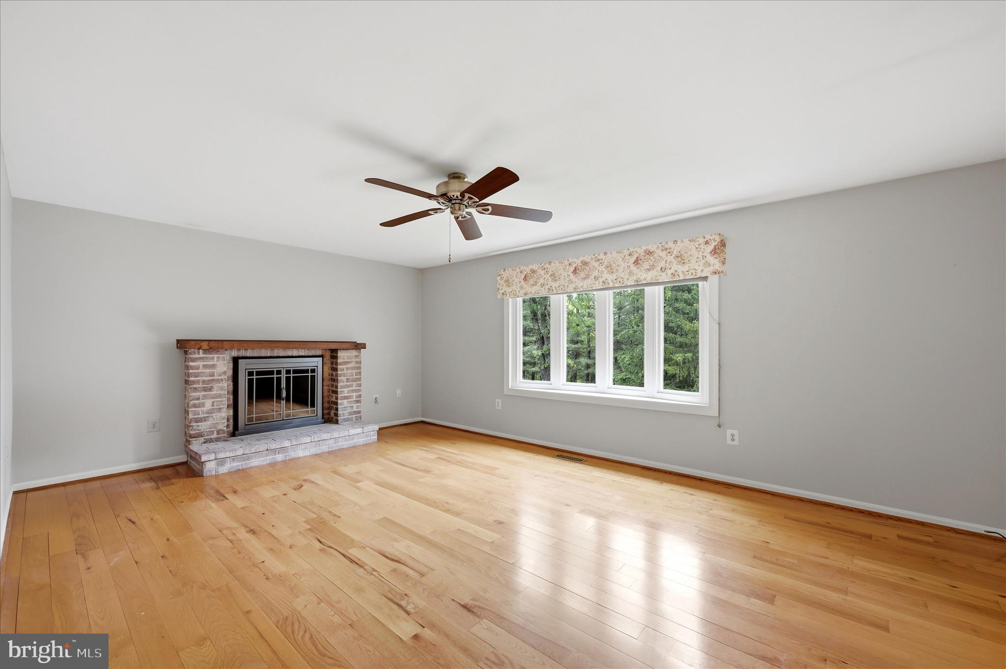 244 High Banks Road Stephenson, VA 22656 - Photo 7 of 45 a view of an empty room with a window and wooden floor