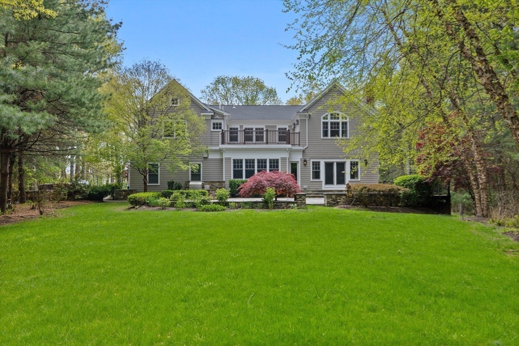 244 Musterfield Road Concord, MA 01742 - Photo 38 of 42 a front view of a house with a garden and trees