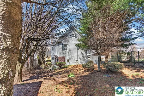 a view of a house with wooden fence