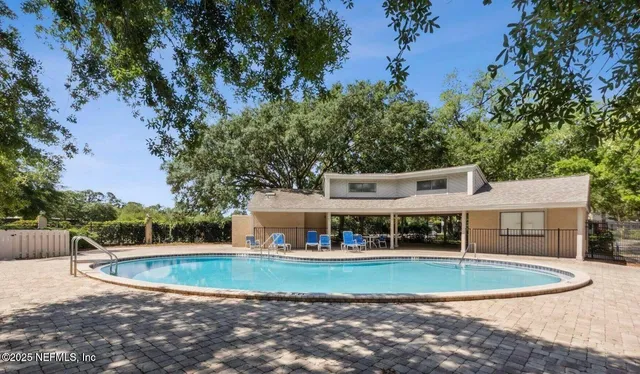a view of house with outdoor space and swimming pool