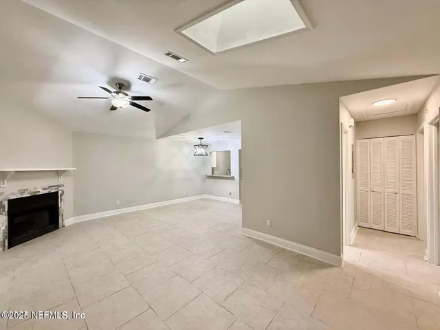 a view of an empty room with a fireplace