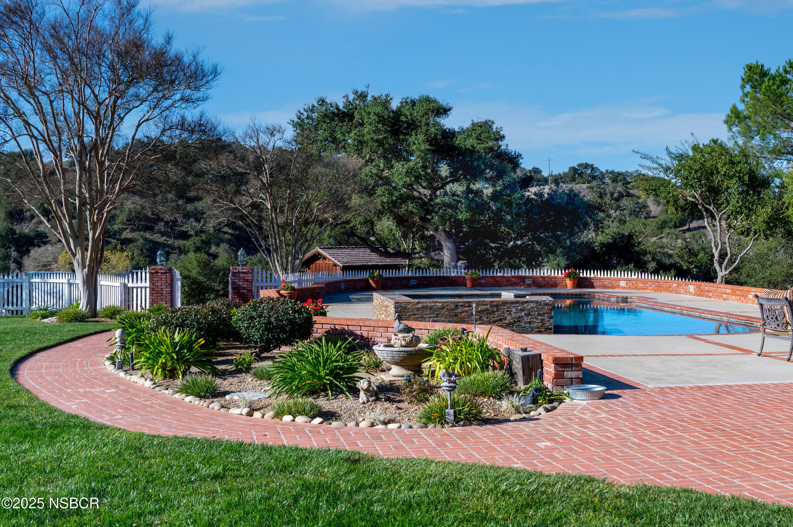 4086 East Oak Trail Road Santa Ynez, CA 93460 - Photo 7 of 57 a view of a swimming pool with a patio