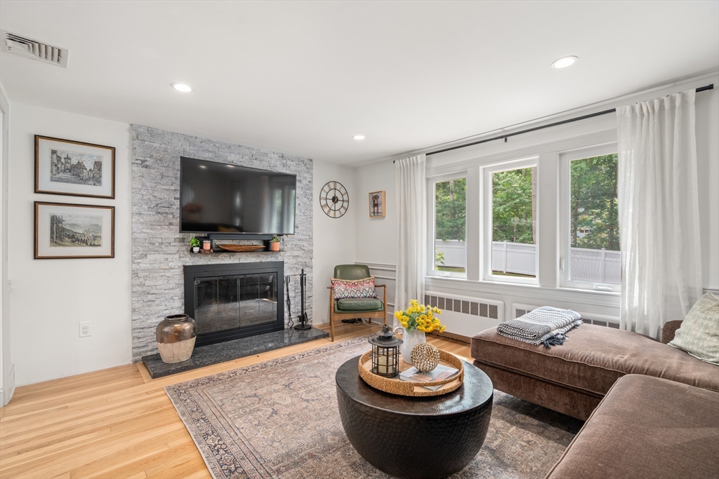 57 Marlboro Road Sudbury, MA 01776 - Photo 11 of 40 a living room with furniture a fireplace and a flat screen tv