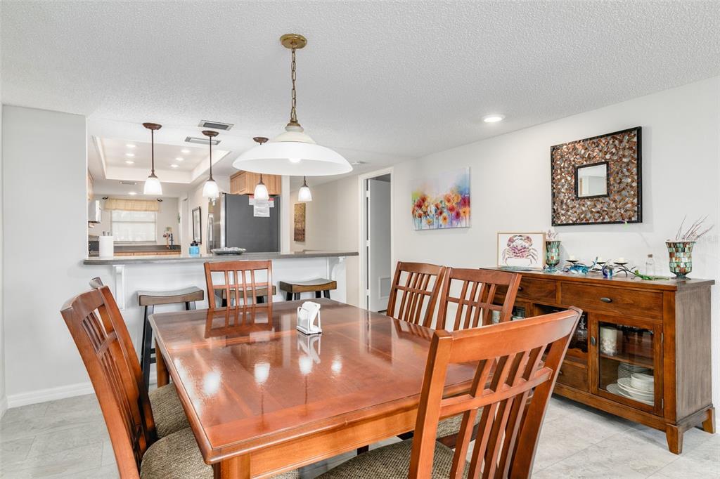 8701 Midnight Pass Road, Unit 106A Sarasota, FL 34242 - Photo 16 of 54 a view of a dining room with furniture