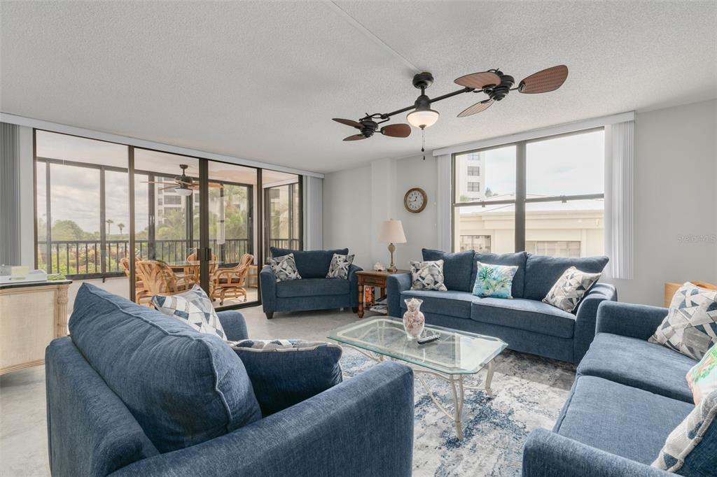 8701 Midnight Pass Road, Unit 106A Sarasota, FL 34242 - Photo 18 of 54 a living room with furniture and a large window