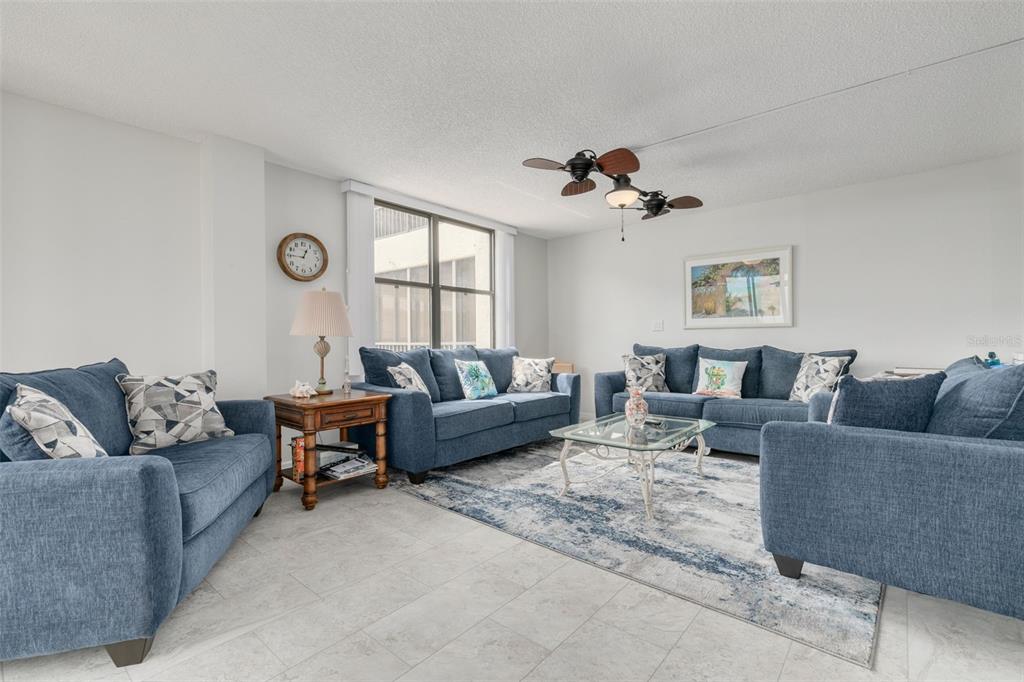 8701 Midnight Pass Road, Unit 106A Sarasota, FL 34242 - Photo 19 of 54 a living room with furniture a view and a window