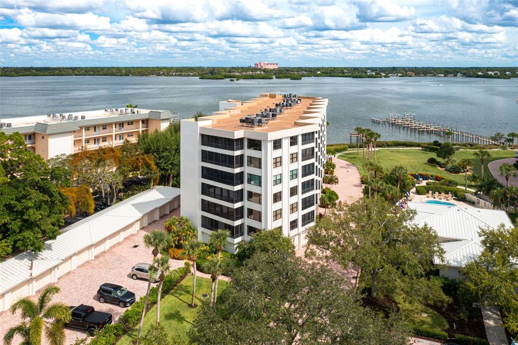 8701 Midnight Pass Road, Unit 106A Sarasota, FL 34242 - Photo 2 of 54 a view of a lake with a building in the background