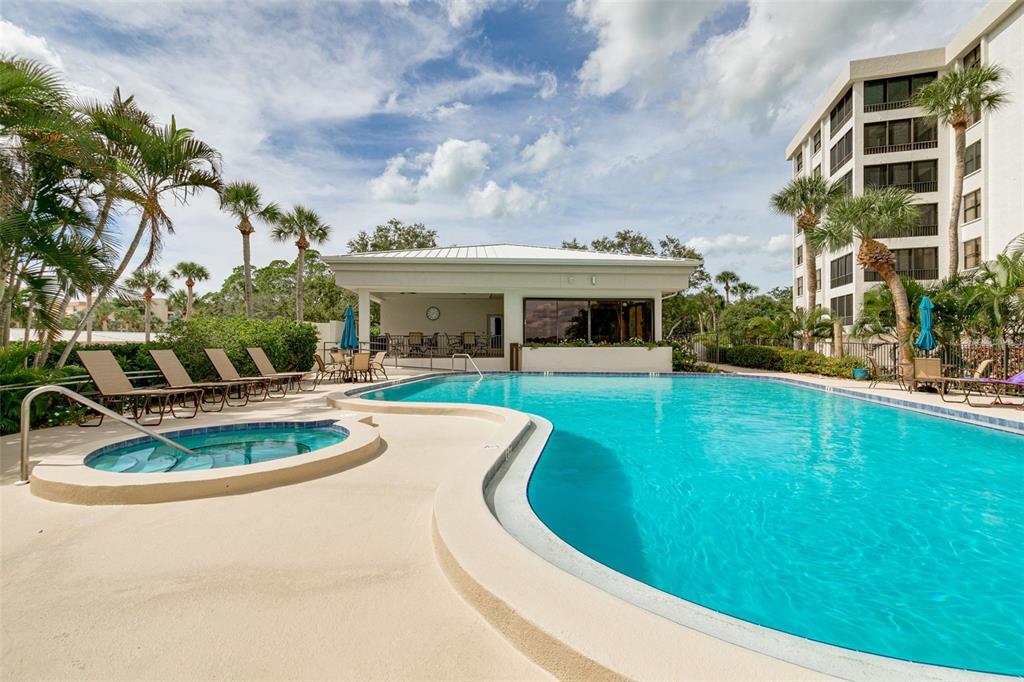 8701 Midnight Pass Road, Unit 106A Sarasota, FL 34242 - Photo 36 of 54 a view of a house with a swimming pool and a yard