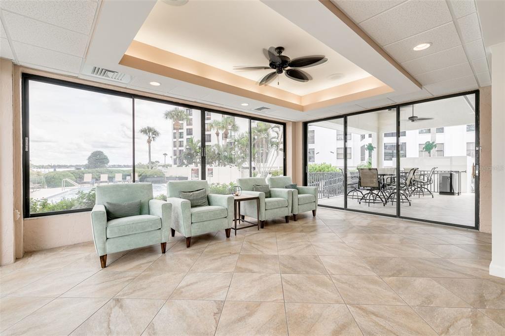 8701 Midnight Pass Road, Unit 106A Sarasota, FL 34242 - Photo 40 of 54 a living room with furniture and a large window