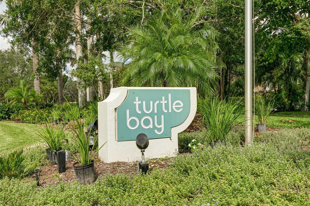 8701 Midnight Pass Road, Unit 106A Sarasota, FL 34242 - Photo 6 of 54 a sign that is sitting in front of a tree